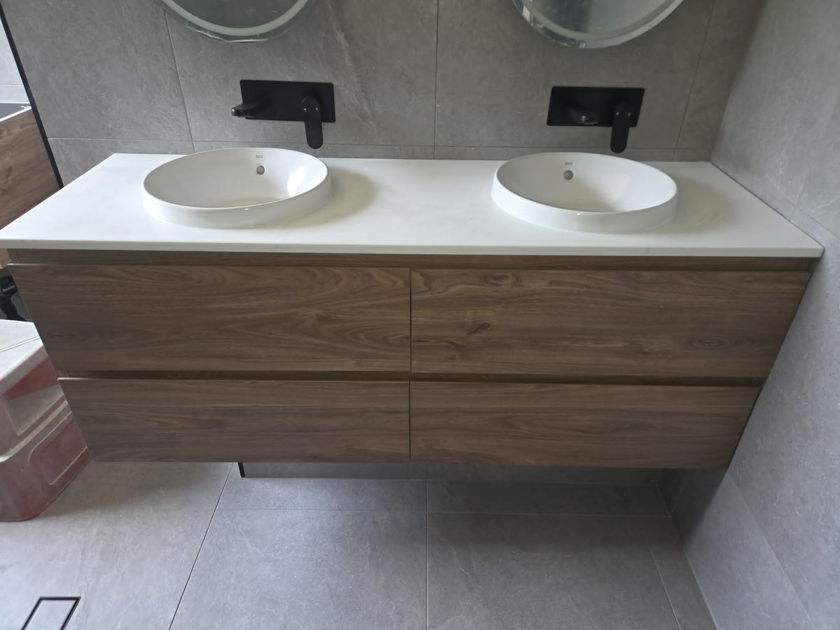 Double vanity with vessel basins and black tapware